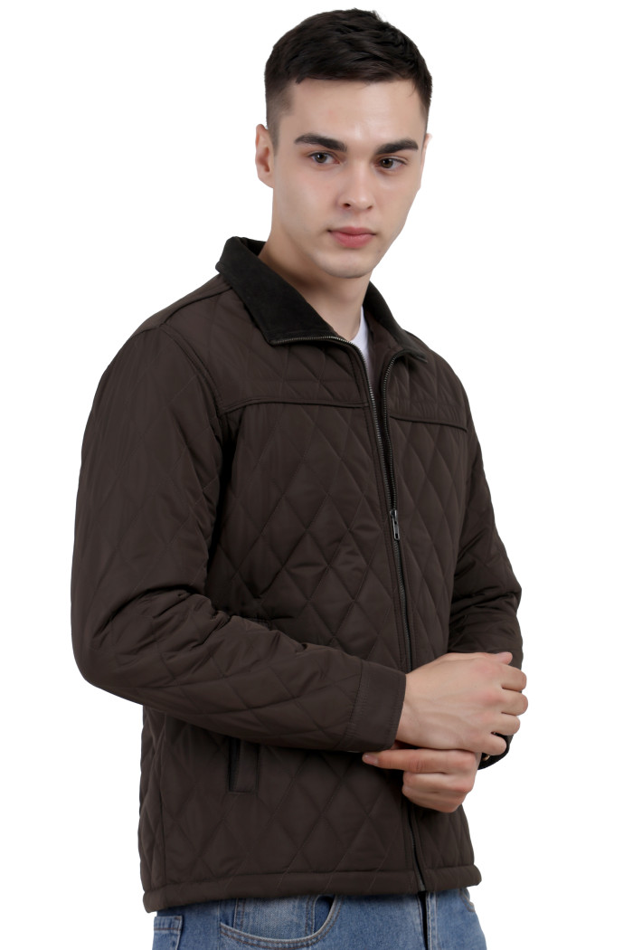 A left pose of a man wearing a Dark Olive quilted jacket with a collar neck, zipper closure and pocket in hand designed for casual winter layering and comfort.